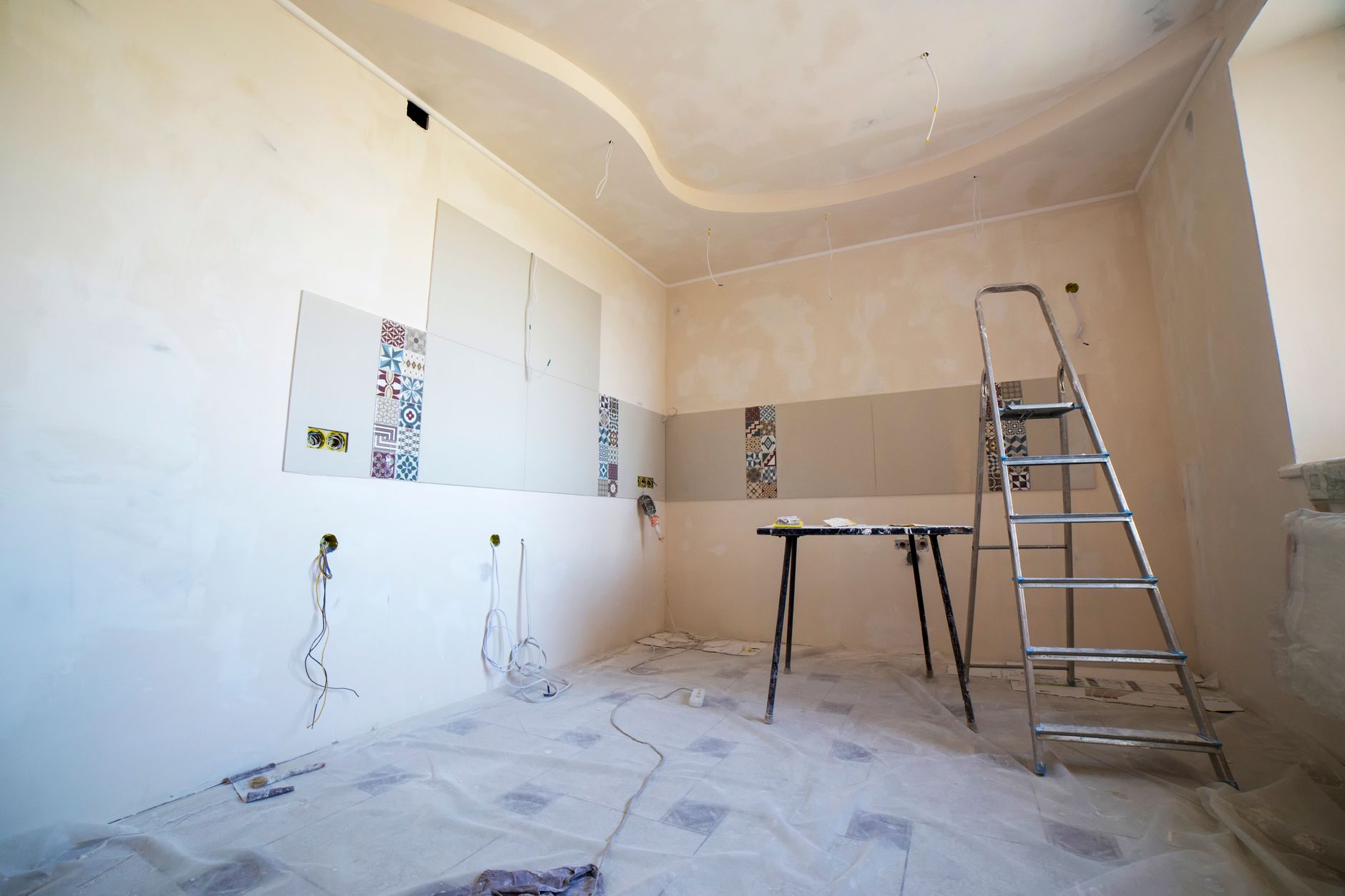 Interior view of a room under renovation with paint, tiles, and tools in Rancho Cucamonga, CA